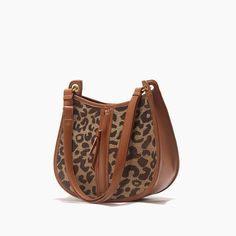 Upgrade Your Style with the Leopard Saddle Shoulder Bag Elevate your fashion game with our Leopard Saddle Shoulder Bag, crafted from premium microfiber leather for a luxurious feel. Designed for the modern woman, this bag combines functionality with trend-setting style, making it the perfect accessory for any occasion. Product Features Microfiber leather upper for durability and a sleek look Polyester lining material for added strength and resilience Zipper closure for secure storage of your essentials Bow decoration adds a touch of charm and femininity Spacious interior with an interior slot pocket for easy organization Available in classic Black or versatile Brown Benefits You'll Love Elevated Style: Stand out from the crowd with the chic leopard print design and sleek saddle shape of th Round Bags, Leopard Bag, Leopard Fashion, Saddle Brown, The Leopard, Round Bag, Leather Pattern, Types Of Bag, The Chic