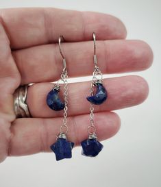 "These genuine moon and star shaped Lapis Lazuli stones are simply wrapped with 24 gauge stainless steel wire and dangle by stainless steel chain. 100% stainless steel earring hooks. They hang from an adjustable 1.25\" stainless steel chain, so you can switch up the length between the stones.  The earrings will come on an earring card with silicone earring backs, and packaged in a charming box, perfect for easy gifting! Lapis Lazuli is a deep blue metamorphic rock used as a semi precious stone t Celestial Star-shaped Pierced Earrings, Celestial Dangle Earrings With Star Charm, Celestial Style Dangle Earrings With Star Charm, Celestial Star-shaped Crystal Earrings For Gift, Celestial Star-shaped Crystal Earrings Gift, Celestial Star-shaped Crystal Earrings, Crescent Earrings With Star Charm As Gift, Crescent Earrings With Star Charm For Gift, Handmade Celestial Dangle Earrings