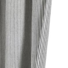 a close up view of a black and white striped curtain