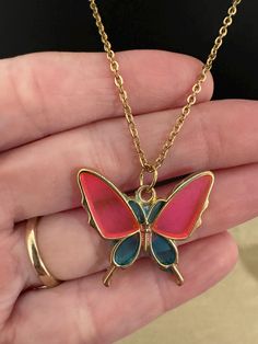 Delicate and enchanting, the Golden Butterfly Dreams Necklace features a beautifully crafted butterfly pendant, plated in lustrous gold over sterling silver. The butterfly's wings are filled with vibrant pink and blue resin, evoking the light and life of a sunlit garden. Hanging on a 22-inch chain, this piece is perfect for adding a touch of nature-inspired elegance to any outfit. Explore other color variations and lengths in my shop to find your perfect match in this timeless collection. Newnan Ga, Golden Butterfly, Light Of Life, Butterfly Pendant, Butterfly Wings, Sterling Silber, Perfect Match, Pendant Necklaces, Nature Inspiration