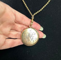 This gold-filled Victorian classic locket has a lovely engraved monogram (SJE?) on its exterior and an original photo shield and ring on its interior, ready for you to insert your own personal treasure. The 28" unique gold-filled chain is a perfect mate for the locket and includes an antique dog clip clasp so you could use the chain with any other pendant or locket in your collection! Bonus! (Note: this locket shows its Victorian roots with a few subtle dents; see pics.) Victorian Round Locket Necklace Stamped 14k, Antique Medallion Locket Necklace Stamped 14k, Victorian Jewelry With Engraving Option For Gifts, Victorian Engraved Rose Gold Locket Necklace, Victorian Engraved Locket Necklace For Memorials, Victorian Etched Locket Necklace For Memorial, Antique Etched Locket Necklace For Memorial, Victorian Medallion Locket Necklace Hallmarked, Vintage Etched Rose Gold Jewelry