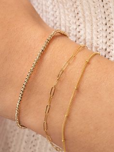 The perfect layering bracelet is dainty and simple — like our Satellite Layering Bracelet! The classic chain goes with any style, and the delicate size fits in with any stack. If your wrist is in need of another layering piece, you've just found it. Pyrite Bracelet, Everyday Bracelet, Rosary Chain, Initial Jewelry, Dainty Bracelets, Layered Bracelets, Paper Clip, Beaded Chain, Mix And Match