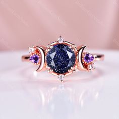 an oval shaped blue diamond surrounded by three smaller purple diamonds on top of each other