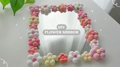 a mirror with flowers on it and the words diy flower mirror