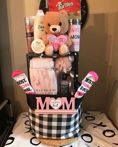 a teddy bear sitting on top of a black and white basket filled with personal care items