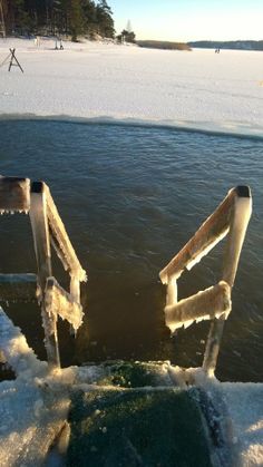 two chairs sitting on top of snow covered ground