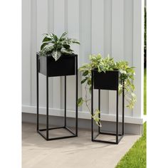 two black planters sitting next to each other