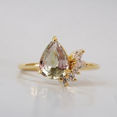 This one of a kind watermelon tourmaline ring with its soft pink and green hue colors will capture your heart. Surrounded with your choice of natural diamonds or CZ. Handcrafted in 14K solid gold. Only one available. 14k solid gold Natural watermelon tourmaline. 8*6mm pear Natural diamonds or CZ 1.25mm ring band ** This item is specially made for you. Please allow 1-2 week lead time. Shipping:Domestic: Free standard shipping within the U.S.International: Free standard shipping for orders over $2 Watermelon Tourmaline Engagement Ring, Watermelon Tourmaline Ring, Tourmaline Engagement Ring, Fall Rings, Future Engagement Rings, Yellow Engagement Rings, Tourmaline Jewelry, Tourmaline Ring, Watermelon Tourmaline