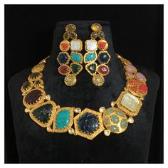 *Material: Brass *Plating: 22K Gold Plated *Stone: Semi Precious Gemstones *DIMENSIONS * *Necklace : Weight 83 gm *Earrings : Length 2.75 Inches , Width 1.25 Inches , Weight 15 gm Each *ABOUT PRODUCT* *This is a High Quality Navratan Necklace Set. *Style Tip : If you like both Traditional and contemporary... This set is certainly for you. *DISCLAIMER* *Product & color may slightly vary due to photographic lighting sources or your screen settings. Bollywood Style 22k Gold Jewelry For Navratri, Bollywood Style 22k Gold Multicolor Jewelry, Multicolor 22k Gold Bollywood Jewelry, Bollywood Style Multicolor 22k Gold Jewelry, Ceremonial 22k Gold Multicolor Jewelry, Multicolor Jewelry With Intricate Design For Navratri, Multicolor Intricate Design Jewelry For Navratri, Multicolor Intricate Jewelry For Navratri, 22k Gold Cutdana Jewelry For Navratri