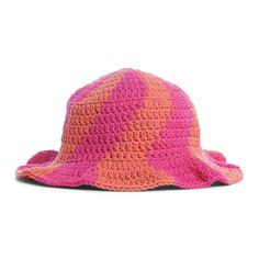 a pink and orange crocheted hat with an open brimmed design on the side