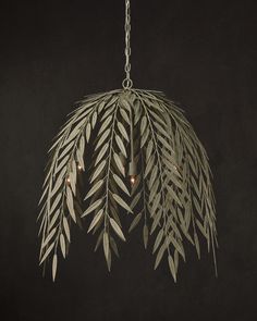 a chandelier hanging from a chain with lights in the center and leaves on it