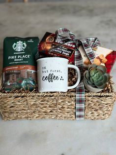 a coffee mug sitting on top of a wicker basket filled with food and snacks