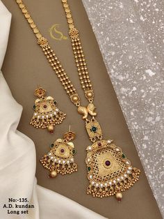 Description :- Indian necklace look like real gold /Gold Necklace /Matar Mala/Long Gold necklace/Indian jewelry/Pakistani jewelry/Beaded Chain Gift yourself a royal look with this perfectly crafted kundan necklace set from Manalisstudio. Crafted with high quality kundan stones and pearls, it is impressive in design. The green enamel artwork adds perfect texture to the design. Perfect for weddings and festivities, this antique necklace set should be put on with your favorite sari or lehenga. 100% Luxury Gold Temple Jewelry Mala, Gold Mala Designs Antiques, Long Gold Necklace Indian, Gold Mala, Long Gold Necklace, Real Gold Necklace, Jewelry Pakistani, Gold Necklace Indian, Necklace Indian