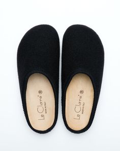 Description: The Nebraska Clog in black is an Italian take on a European classic. The Nebraska is one of the most versatile clog style slippers available. From home to the office to weekend, the minimalist design of these clogs will take you anywhere in comfort. The anatomical self-molding latex and thermoforming cork insole provide a firm customized comfort, and the insole is completely removable for cleaning. LeClare Slippers are exclusively handcrafted in our small-batch factory in Treviso, I Comfortable Black Slip-ons With Leather Sole, Classic Black Mules With Rubber Sole, Classic Black Slip-on Clogs, Classic Black Slippers With Rubber Sole, Casual Black Mules With Cork-bed Midsoles, Classic Black Clogs With Cushioned Footbed, Modern Black Slippers With Rubber Sole, Black Modern Slippers With Rubber Sole, Comfortable Black Slip-on Clogs