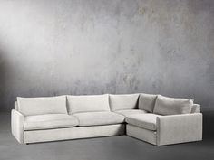 a white couch sitting in front of a gray wall