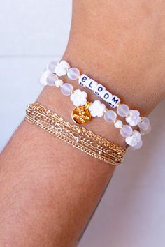 Embrace your personal growth and flourish with our "Bloom" bracelet from Little Words Project. This delicately crafted piece symbolizes new beginnings and the beauty of blooming where you are planted. Perfect for inspiring daily positivity and strength, it features elegant flower beads and a reminder to thrive in all aspects of life. Whether you're treating yourself or gifting a loved one, the "Bloom" bracelet is a chic reminder to keep growing and shining. Celebrate your journey with this beaut Delicate White Adjustable Jewelry, Everyday White Flower Jewelry, Inspirational White Bracelets For Friendship, Inspirational White Jewelry For Gifts, Inspirational White Jewelry Gift, Delicate White Bracelets For Spring, White Delicate Bracelet For Spring, Delicate White Bracelet For Spring, Delicate White Jewelry For Spring