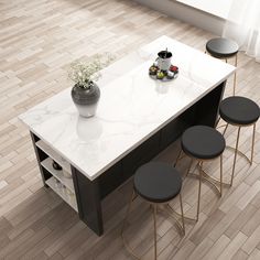 a kitchen island with three stools next to it