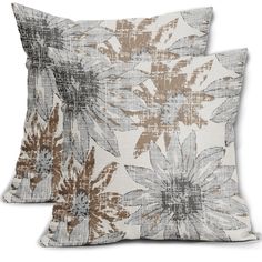 two decorative pillows with brown and white flowers on the front, one is made out of linen