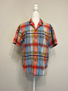 "I love this rainbow colored plaid shirt!  Plaids in bright colors are great for the summer! You can tie the front up and wear this cropped or wear it long for different looks.  The fabric is 100% cotton with a chambray feel.  It is part of Liz Claiborne's Lizwear line that was popular in the 80s & 90s and sold at department stores. This is just a fun top!  It's in excellent condition!  I bought it at an estate sale.  It's a size Small.  Please see measurements below.  Plaid is timeless.  This is a perfect vintage top for the warm weather!  Thanks for looking!   Measurements taken laying flat: please double for chest & waist Armpit to armpit 20\" Waist/middle 19.75\" Shoulders 19\" Short Sleeves from shoulder seam 9\" Length 26\"" Retro Short Sleeve Camp Shirt For Spring, Plaid Camp Collar Shirt For Summer, Summer Casual Plaid Shirt, Multicolor Relaxed Fit Camp Shirt With Short Sleeves, Vintage Cotton Short Sleeve Shirt For Summer, Retro Short Sleeve Camp Shirt With Relaxed Fit, Plaid Short Sleeve Top For Summer, Short Sleeve Plaid Flannel Shirt For Spring, Casual Multicolor Short Sleeve Shirt For Summer