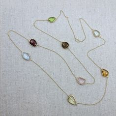 Semi-precious stone with 18k Solid Gold Necklace Stone: Semi-Precious Stone (Citrine, Blue Topaz, Rose Quartz, Lemon Quartz, Garnet, Green Amethyst, Peridot, Smokey Quartz)           -Shape: Free Form           -Cut: Double-Sided Cabochon           -Color: Orange, Blue, Pink, Yellow, Red, Light Green, Brown, Green           -Weight: ~26ct           -Quantity:  8 pieces           -Quality: Please refer to the picture, only 1 piece is available Necklace Length: 81cm (32in) The stones were bezel-se Oval Citrine Birthstone Jewelry, Elegant Multicolor Jewelry For Birthdays, Elegant Multicolor Jewelry For Birthday, Fine Jewelry Briolette Birthstone Gemstones, Gold Teardrop Necklace With Gemstone Accents, Gold Multi-stone Fine Jewelry Gemstones, Round Citrine Jewelry With Gemstone Accents, Gold Multi-stone Gemstones In Fine Jewelry Style, Oval Yellow Gold Birthstone Necklace With Gemstone