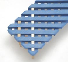 several blue plastic pallets stacked on top of each other in the shape of a triangle