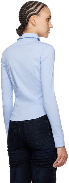 Stretch cotton-blend poplin shirt. · Twisted construction · Spread collar · Half-zip closure · Darts at chest and back · Zip vents at curved hem · Crystal-cut logo at sleeve · Zip vent at cuffs Supplier color: Light blue Cotton Blouse With Fold Down Collar, Modern Tops With Concealed Placket, Slim Fit Tops With Concealed Placket For Business Casual, Modern Blue Tops For Office, Modern Blue Office Tops, Modern Fitted Blue Shirt, Modern Blue Slim Fit Shirt, Office Cotton Stretch Shirt, Stretch Cotton Shirt For Office