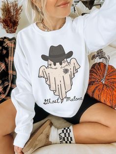 Show off your cowghoul aesthetic in our spooky Ghost Malone shirt. This trendy Halloween sweatshirt is slightly disressed and oversized, perfect for a cozy fall outfit. * Ultra soft * Distressed design * Pre-shrunk * Universal fit * True to size * DTG Printing * Brand - Gildan Refunds/Exchanges: * No Cancellations * No returns/exchanges * All sales are final Sizing: Our graphic tees and sweatshirts are a true to size standard unisex fit. For an oversized look, please size up. For a TShirt dress Oversized Graphic Sweater Outfit, Horror Long Sleeve T-shirt For Fall, White Band Merch Sweatshirt For Fall, White Band Merch Tops For Fall, White Band Merch Top For Fall, Horror Crew Neck Tops For Fall, Graphic Sweater Outfit, Monster Sweater, Spooky Sweater