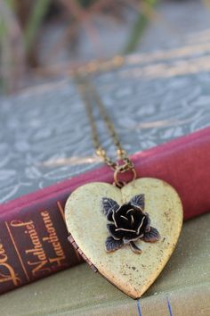 Note: I am unable to put quotes in the heart shaped vintage lockets. Thank you for understanding. This rustic heart locket is restored vintage. I added a dark bronze 3D Rose on the front. The contrast of the colors is stunning. The locket is generous, measuring 47mm! It holds two photos and the inside has a copper perimeter to hold them in tightly. It hangs on a brass chain and closes securely with a lobster clasp. Gorgeous gift or a lovely vintage accessory for you collection. It comes beautifu Vintage Heart Charm Jewelry For Valentine's Day, Vintage Heart Pendant Necklace For Valentine's Day, Vintage Heart Charm Jewelry Gift, Victorian Heart Necklace With Vintage Charm, Victorian Heart Locket Necklace For Gift, Victorian Heart Locket Necklace As Gift, Vintage Heart Charm Necklace For Valentine's Day, Antique Heart-shaped Necklace For Anniversary, Antique Heart Necklace For Anniversary