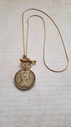 For your favorite Australian, this necklace will be a treasure! Your choice of a silver-toned Australian 50-cent coin with the image of Queen Elizabeth on one side and an emu and kangaroo on the reverse side or a gold-toned Australian dollar coin with Queen Elizabeth on the front and kangaroos on the reverse side. The coin dangles from either a 16" or 18" matching chain with a front toggle closure. Welcome to Recycled Finery!  I repurpose old jewelry, coins, beads, vintage buttons, watch parts, Medallion Coin Necklace With Vintage Charm As A Gift, Vintage Charm Medallion Coin Necklace As Gift, Vintage Charm Medallion Coin Necklace For Gift, Vintage Medallion Coin Necklace As A Gift, Nickel Free Round Pendant Necklace For Commemoration, Vintage Charm Coin Necklace With Round Pendant As Gift, Vintage Charm Coin Necklace As Gift, Vintage Charm Coin Necklace Gift, Vintage Round Medallion Necklace Nickel Free