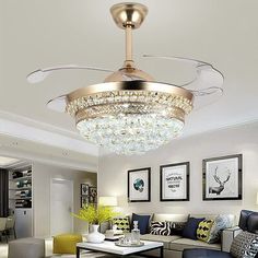 a living room filled with lots of furniture and a chandelier above the couch