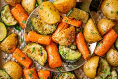 roasted potatoes and carrots with herbs on a serving dish