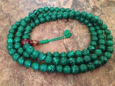 This full mala 108 beads prayer mala is made by malachite beads. This mala is used for meditation purposes or can always be used as necklace or bracelet by wrapping around your wrist. The length of the mala is about 35 inches and bead size about 7-8mm. Beads are strung on a durable nylon cord. This mala can be used both as bracelet by wrapping around your wrist or as a necklace. Malachite prayer bead malas provide powerful grounding energy that clears obstructions and blockages and helps avert c Spiritual Jade Beads For Meditation, Green Spiritual Beads For Healing, 8mm Oval Beads For Gifts, Green Spiritual Beads, 108 Count, Green Hand-strung Spiritual Mala, Beaded Malachite Round Bead Necklaces, Malachite Jewelry With 8mm Round Beads, Green Mala With 8mm Beads For Healing, Green Gemstone Beads Mala For Healing