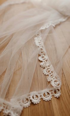 a wedding veil is laying on the floor