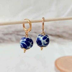 We combine art and elegance to create this beautiful piece. Our handmade earrings will be the perfect element to make your outfit standout. You could have the entire collection or gift them to someone special.  Material: Real Gold plate brass, Talavera gemstone  Dimensions: Drop Length 3cm, weight 2g Features : Lightweight, Unique and Simple design The Talavera of Puebla is part of the intangible heritage of humanity, declared by UNESCO. It is a type of majolica ceramic with a mixture of Chinese, Italian, Spanish, and indigenous techniques, and its colors are obtained from natural pigments. Its main characteristics are its vitreous finish and the use of bulky cobalt blue, this made it even more exclusive and ostentatious than Spanish craftsmanship. Its production requires at least 120 hour Unique Round Bead Earrings As Gift, Unique Round Beads Earrings For Gift, Handmade Artistic Earrings With Round Beads, Artistic Handmade Earrings With Round Beads, Artistic Round Beads Earrings As A Gift, Artistic Round Bead Earrings For Gifts, Nickel-free Beaded Earrings As Gift, Nickel-free Round Bead Earrings As Gift, Unique Handmade Gold-plated Earrings