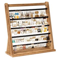 a wooden display case holding many pairs of earrings