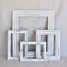 four white frames sitting next to each other