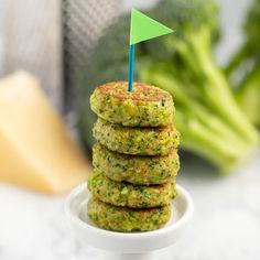 a stack of broccoli patties with a green flag sticking out of it