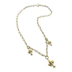 A delicate handmade necklace from the Victorian-era, circa 1890, featuring well-sculpted fleur-de-lis. The chain is made from 14k gold wire, which was hand-twisted into elongated oval links, and then twisted again, halfway, reminiscent of a Mobius strip. Suspended from the chain are three fleur-de-lis in descending size, with the largest in the center of the necklace. Each fleur-de-lis hangs from a wire-twisted round link. This graceful, feminine necklace is 15 1/2 inches long. The largest fleur-de-lis is 3/4 inch, and drops down one inch from the necklace. It weighs 6.75 grams. A spring ring has been recently added for a more secure closure. Mobius Strip, Feminine Necklace, Elongated Oval, Gold Wire, Handmade Necklace, Victorian Era, Spring Rings, Handmade Necklaces, Chains Necklace