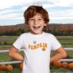 Fall festivals, pumpkin patches and apple picking...all of these activities are made a little sweeter with this Lil' Pumpkin tee!  It features the cutest little pumpkin you ever did see with a retro vibe font.  Even better is you can grab one for the whole family, even the dog, and pick those pumpkins or eat those caramel apples in style.   Want matching shirts for some fun family pics? Mommy Pumpkin Short Sleeve Tee https://www.etsy.com/listing/1770650245/mommy-pumpkin-unisex-jersey-short-sleeve Daddy Pumpkin Short Sleeve Tee https://www.etsy.com/listing/1756473892/daddy-pumpkin-unisex-jersey-short-sleeve The fabric is 100% cotton for solid colors. Polyester is included for heather-color variants. These fabrics are prime materials for printing. The shoulders have twill tape for improved d Playful Pre-shrunk T-shirt For Fall, Playful Short Sleeve T-shirt For Fall, Playful Short Sleeve Fall T-shirt, Fall Festivals, Halloween Shirts Kids, Pumpkin Patches, Family Pics, Apple Picking, Fall Kids