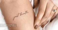 a woman's leg with the words just breathe tattooed on it, in black ink