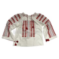 a white blouse with red trims and tassels