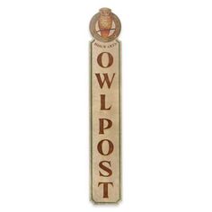 a wooden sign with the words owlpost on it