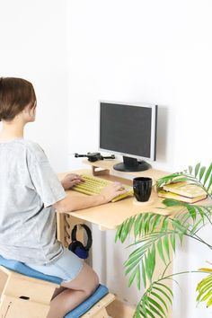 a person sitting at a computer desk with a keyboard and mouse in front of them