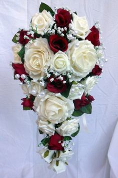 a bridal bouquet with red and white roses