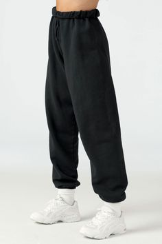 Side view of model from the waist down wearing the oversized loose fit black french terry Oversized Jogger with an elastic waistband and ankle cuffs Brown Joggers, Form Fitting Tops, Black Sweats, Joah Brown, Black French, Bare Shoulders, Terry Fabric, French Terry Fabric, Ankle Cuffs