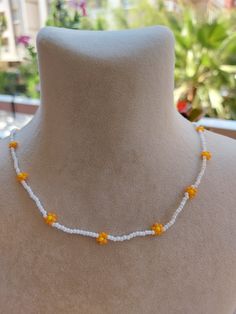 A pretty necklace perfect for everyday wear. So cute and dainty this layering necklace looks lovely on it's own on layered with other necklace. Daisy beaded necklace is an excellent and elegant gift for your lovelies. Choker necklace is made of white and orange bead. You can wear the seed bead necklace to a wedding party and look very special. This tiny choker is made of glass beads. Please select necklace length from the drop-down menu or request an arbitrary length. If you would like a bigger/smaller size please contact me. You can press the contact button. Summer Beaded Necklaces With Flower Charm As Gift, Summer Gift Beaded Necklace With Flower Charm, Beaded Flower Necklace For Summer Gifts, Summer Flower Beaded Necklaces, Summer Flower Necklace With Tiny Beads, Summer Flower Necklace With Tiny Round Beads, Summer Beach Flower Necklace With Flower Charm, Summer Beach Flower Necklace With Charm, Yellow Flower Necklace For Summer