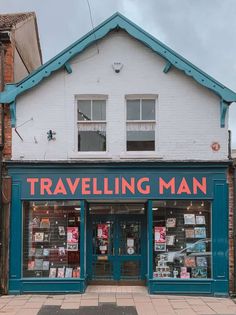 a building with a sign that says traveling man on it's front and side