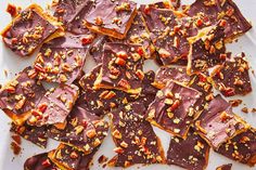 a white plate topped with pieces of chocolate and nuts