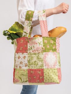 a woman is holding a bag full of food