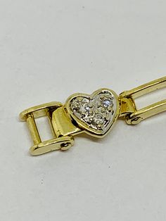 "Beautiful excellent condition 10kt yellow gold heart motif diamond encrusted bracelet. Genuine diamonds are set in a white gold hearts. Twelve hearts make up this link bracelet which measures about 7 1/2\" long when open. Fabulous unusual secure clasp. This bracelet is straight out of a jewelry stores jewelry case and was never worn. Perfect condition. Mother's Day and Easter are coming up! Weighs about 7.32 grams. Nice sparkly white diamonds . Hallmark JJ.about 1/3 ct if high quality diamonds. Anniversary Gold Bracelet With Brilliant Cut Diamonds, Fine Jewelry Diamond Gold Bracelet For Anniversary, Heirloom Diamond Bracelets For Anniversary, Classic Diamond Gold Bracelet For Anniversary, 14k Gold Diamond Bracelet With Brilliant Cut For Anniversary, 14k Gold Brilliant Cut Diamond Bracelet For Anniversary, Anniversary Yellow Gold Bracelet With Diamond Accents, Yellow Gold Jewelry Stamped 14k With Double Heart, Anniversary Gold Bracelet Hallmarked Round Shape